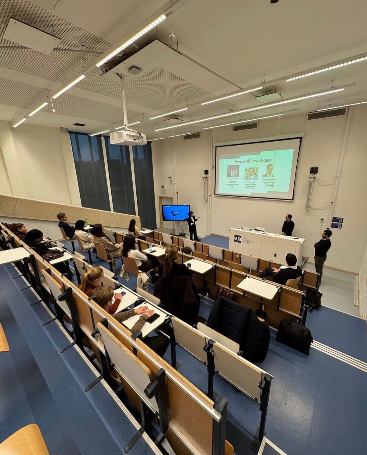 Roots Connect event in an auditorium: students and young professionals listening to a talk.